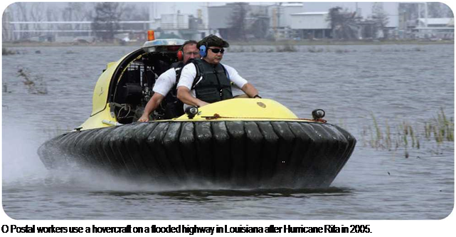 Подпись: О Postal workers use a hovercraft on a flooded highway in Louisiana after Hurricane Rita in 2005. 