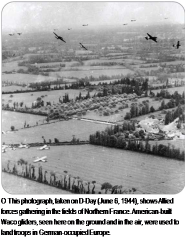 Подпись: О This photograph, taken on D-Day (June 6, 1944), shows Allied forces gathering in the fields of Northern France. American-built Waco gliders, seen here on the ground and in the air, were used to land troops in German-occupied Europe. 