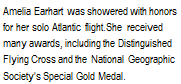 Подпись: Amelia Earhart was showered with honors for her solo Atlantic flight.She received many awards, including the Distinguished Flying Cross and the National Geographic Society's Special Gold Medal.