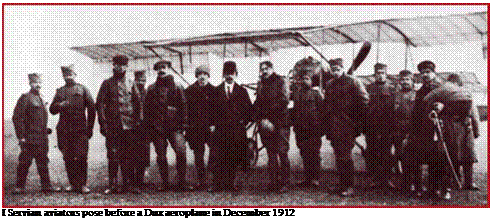 Подпись: I Servian aviators pose before a Dux aeroplane in December 1912 
