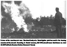 Подпись: A view of the merciless air war. The dead body of a Soviet fighter pilot lies next to the burning^ remains of his aircraft. According to Soviet sources, 322 WS aircraft were shot down on June' 22.1941.(Photo: Russian Aviation Research Team.) 