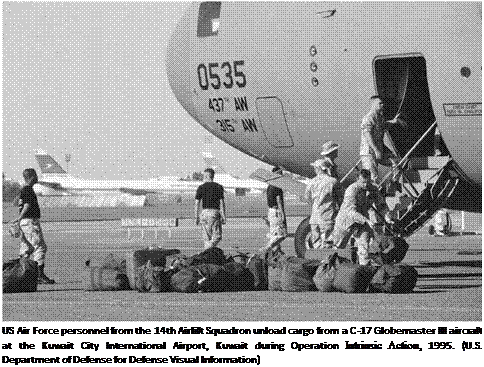 Подпись: US Air Force personnel from the 14th Airlift Squadron unload cargo from a C-17 Globemaster III aircraft at the Kuwait City International Airport, Kuwait during Operation Intrinsic Action, 1995. (U.S. Department of Defense for Defense Visual Information) 