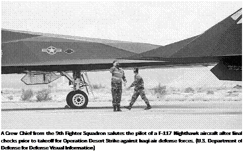 Подпись: A Crew Chief from the 9th Fighter Squadron salutes the pilot of a F-117 Nighthawk aircraft after final checks prior to takeoff for Operation Desert Strike against Iraqi air defense forces. (U.S. Department of Defense for Defense Visual Information) 