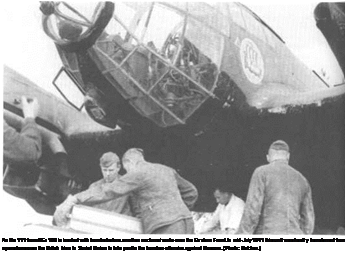 Подпись: An He 111 from KGr 100 is loaded with bombs before another nocturnal sortie over the Eastern Front. In mid-July 1941 this unit was hastily transferred from operations over the British Isles to Soviet Union to take part in the bomber offensive against Moscow. (Photo: Batcher.) 